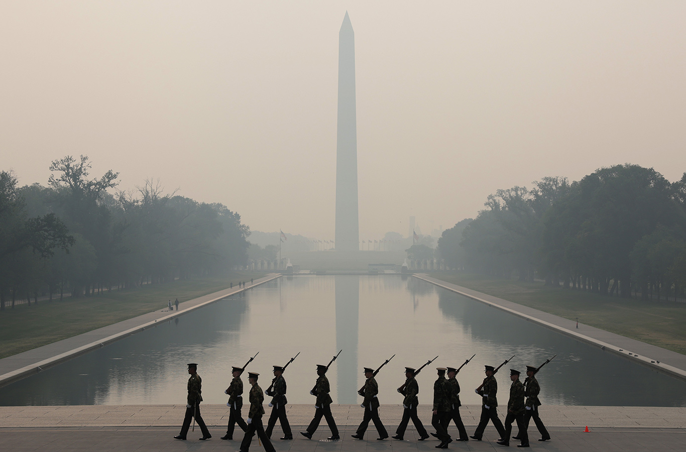 Members of the US Marine Corps rehearse in hazy smoke at the Lincoln Memorial in Washington DC